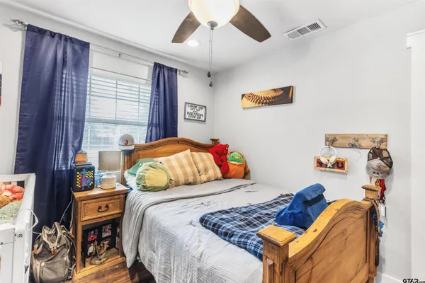 a bedroom with a bed and a chandelier