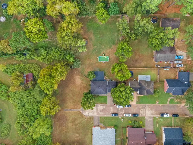 an aerial view of a house with a yard