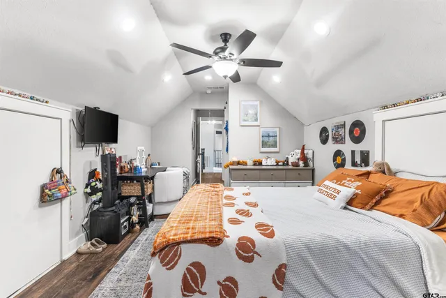 a bedroom with furniture a bed and a chandelier