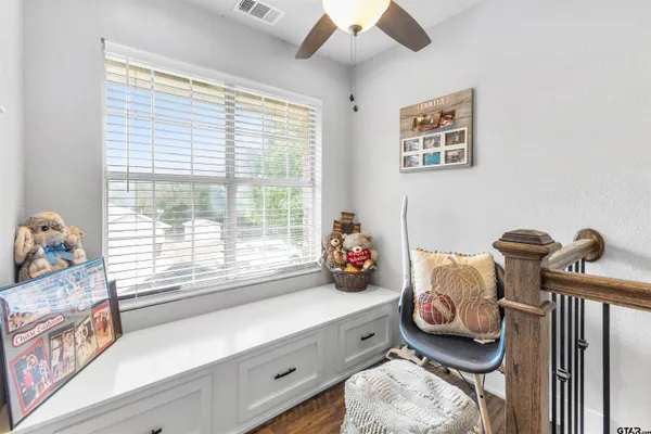 a bedroom with furniture and a window