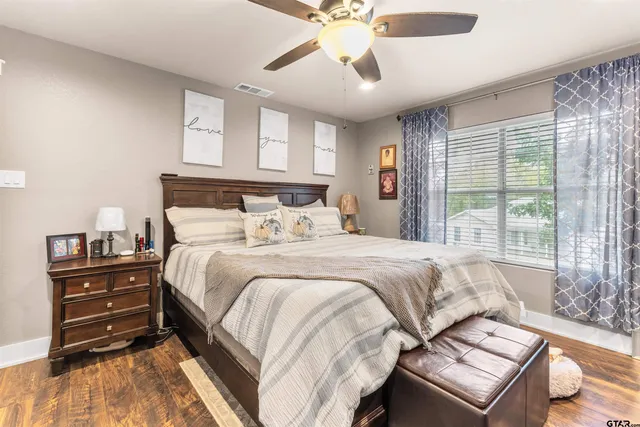 a bedroom with a bed and a window