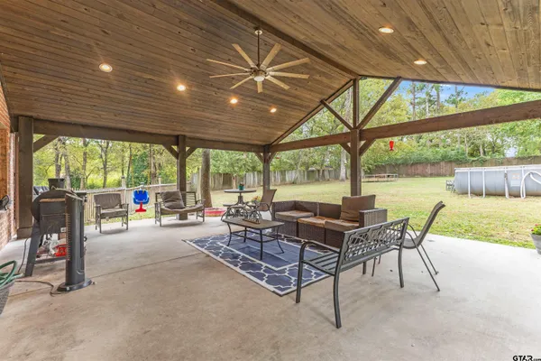 a building outdoor space with patio furniture and garden