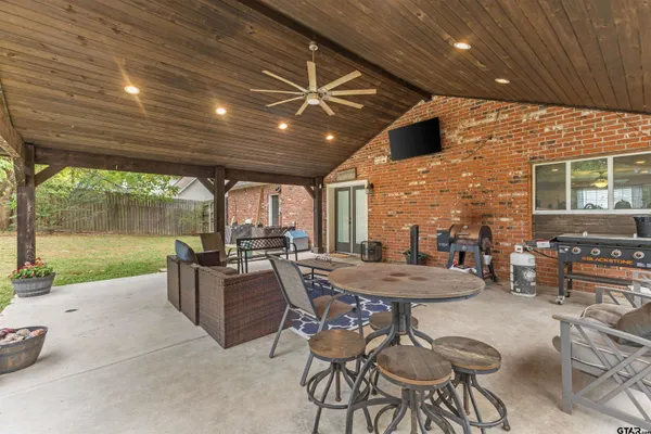 a view of a patio with a table and chairs
