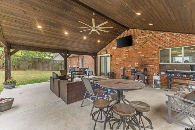 a view of a patio with a table and chairs
