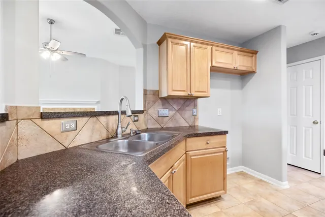 a kitchen with stainless steel appliances granite countertop a sink window and cabinets