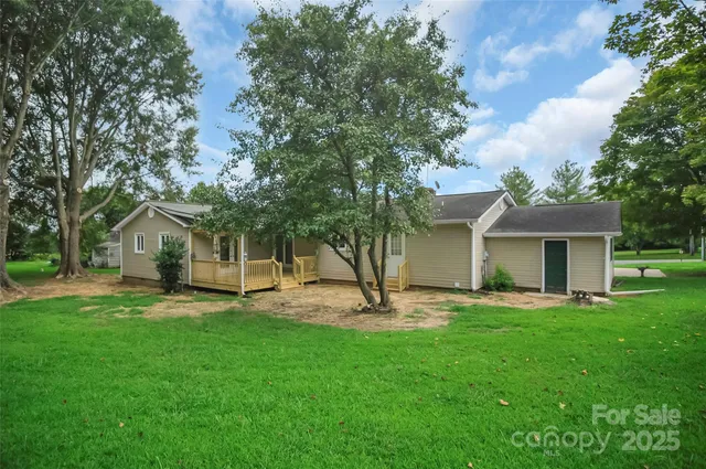 a view of a house with a yard and sitting area