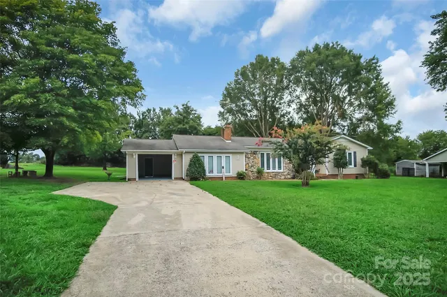 a front view of house with yard and green space