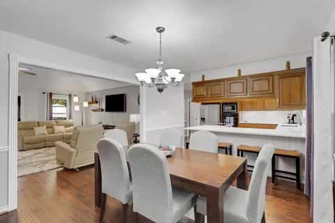 a view of a dining room with furniture and wooden floor