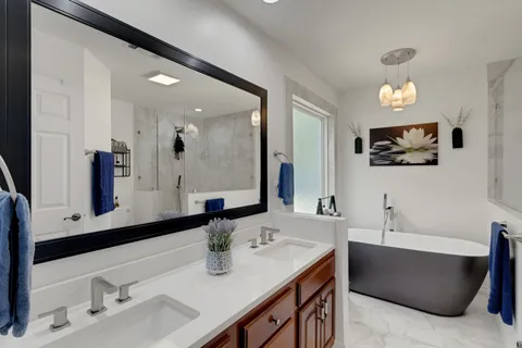 a bathroom with a tub sink and mirror