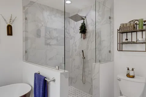 a bathroom with a shower toilet and sink