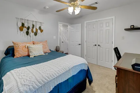 a bedroom with a bed and a chandelier