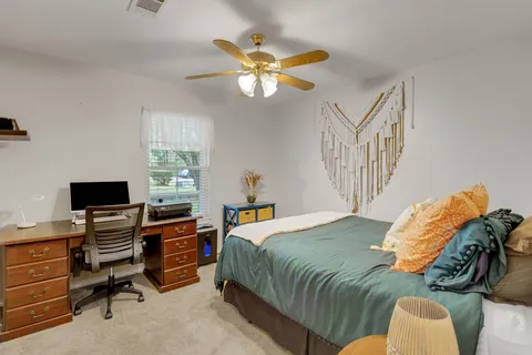 a bedroom with a bed and a window