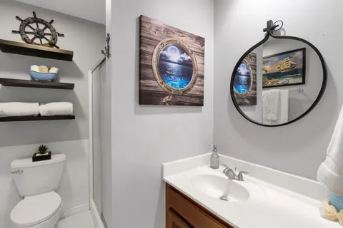 a bathroom with a toilet a sink and a mirror