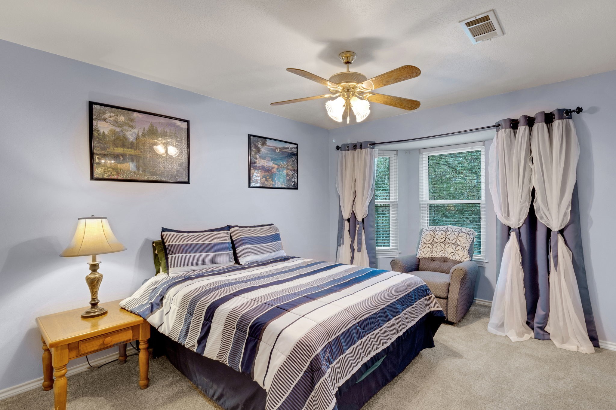 80 Lake Grove Drive Coldspring, TX 77331 - Photo 29 of 50 a bedroom with a bed and a chandelier