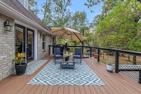 a view of a roof deck with chair and wooden floor
