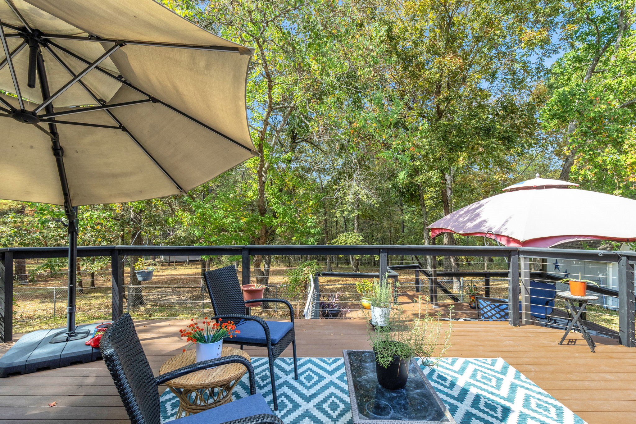80 Lake Grove Drive Coldspring, TX 77331 - Photo 33 of 50 an outdoor space with furniture and umbrella