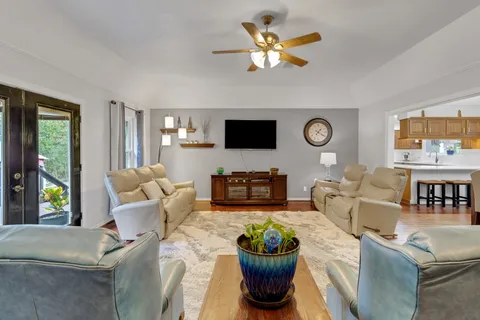 a living room with furniture a fireplace and a flat screen tv