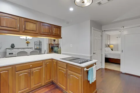 a kitchen that has a sink cabinets and wooden floor