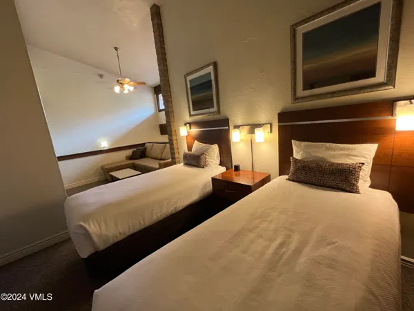 a bedroom with bed tv and window