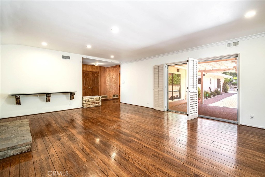 16258 Bertella Drive Encino, CA 91436 - Photo 11 of 45 a view of a living room hardwood floor and a kitchen with wooden floor