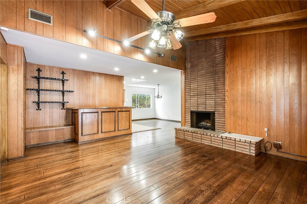 16258 Bertella Drive Encino, CA 91436 - Photo 13 of 45 a view of a livingroom with wooden floor and a kitchen space