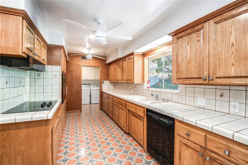 16258 Bertella Drive Encino, CA 91436 - Photo 17 of 45 a large kitchen with kitchen island granite countertop a sink a counter top space and stainless steel appliances