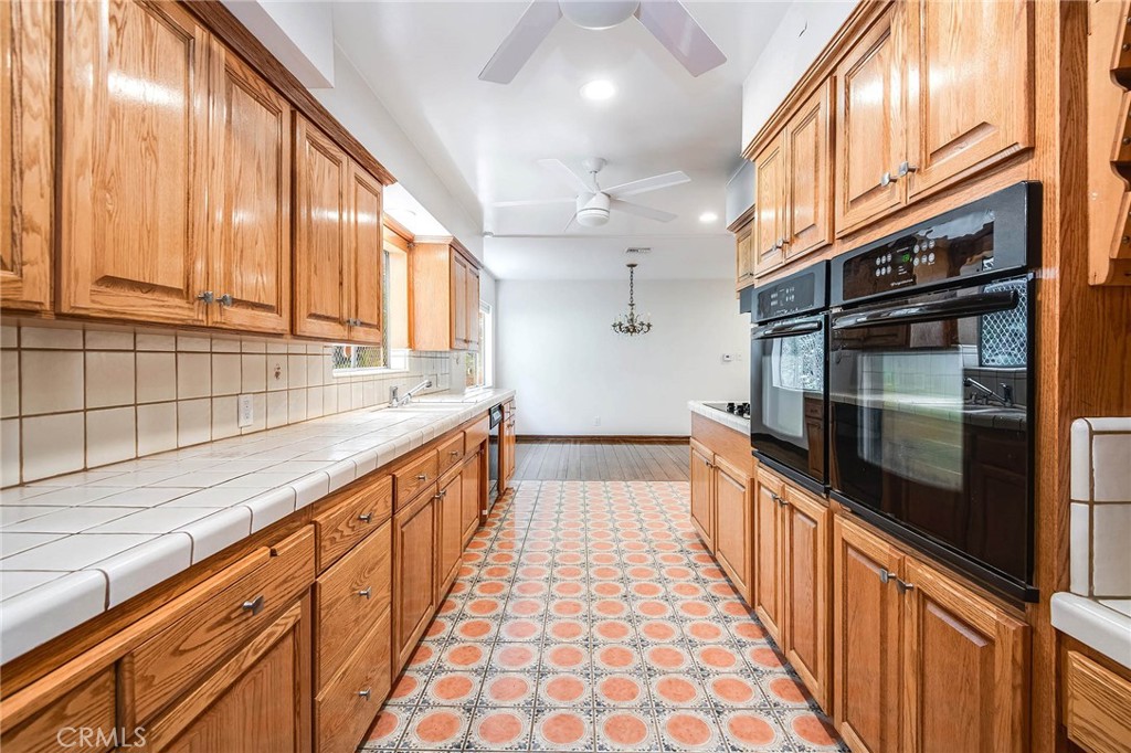 16258 Bertella Drive Encino, CA 91436 - Photo 18 of 45 a kitchen with stainless steel appliances a sink and cabinets