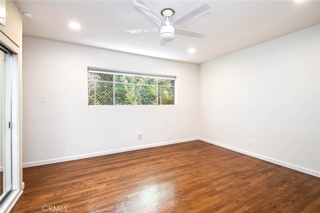 16258 Bertella Drive Encino, CA 91436 - Photo 21 of 45 an empty room with wooden floor and windows