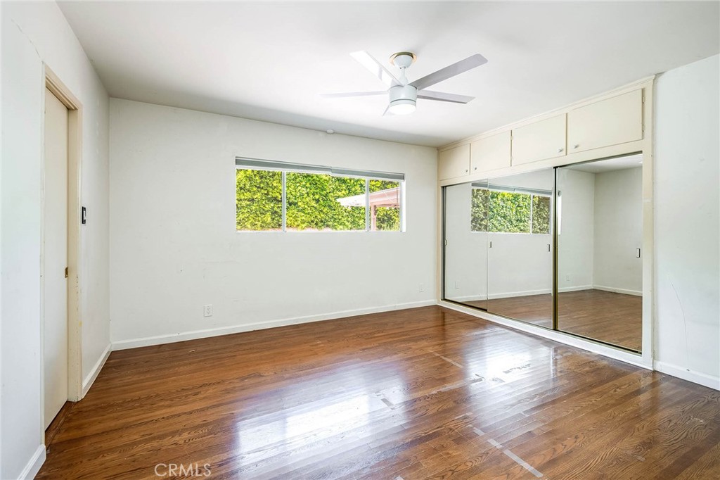 16258 Bertella Drive Encino, CA 91436 - Photo 23 of 45 an empty room with wooden floor cabinet and windows