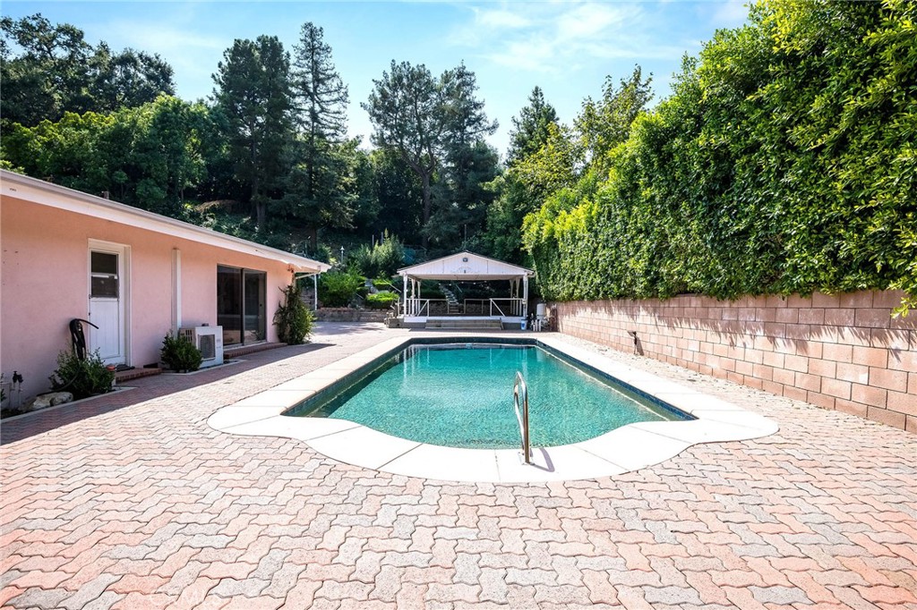 16258 Bertella Drive Encino, CA 91436 - Photo 33 of 45 a house with trees in the background