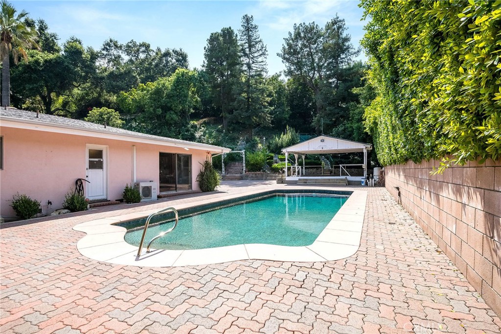 16258 Bertella Drive Encino, CA 91436 - Photo 34 of 45 a house with swimming pool in front of it