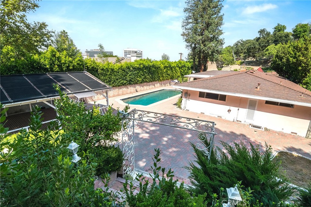 16258 Bertella Drive Encino, CA 91436 - Photo 40 of 45 a view of a swimming pool with a yard