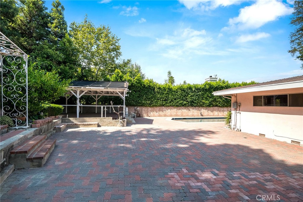 16258 Bertella Drive Encino, CA 91436 - Photo 41 of 45 a view of a house with backyard and sitting area