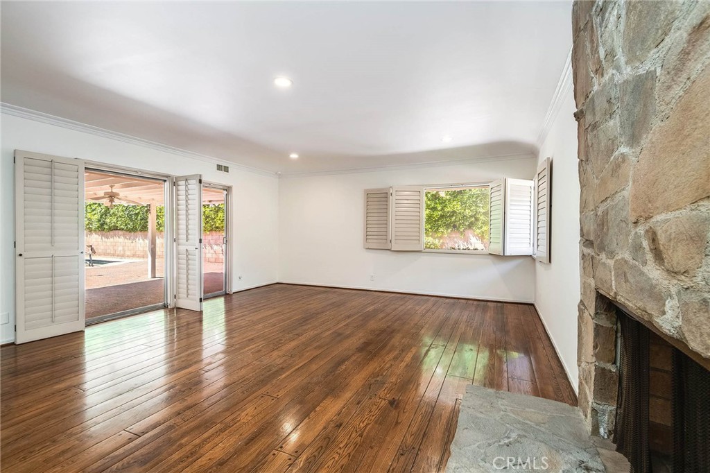 16258 Bertella Drive Encino, CA 91436 - Photo 10 of 45 wooden floor in an empty room with a fireplace