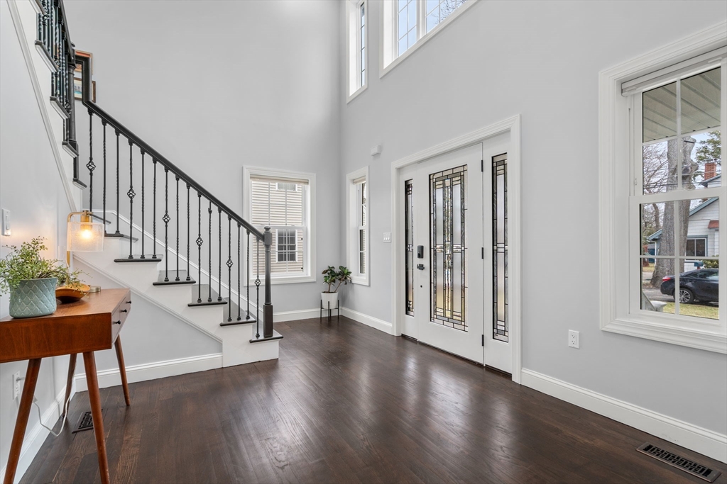 6 Ash Street Natick, MA 01760 - Photo 11 of 39 a view of a hallway with wooden floor and stairs