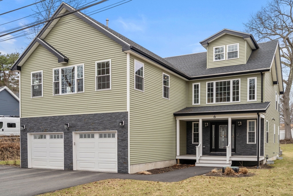 6 Ash Street Natick, MA 01760 - Photo 2 of 39 a front view of a house with a garage