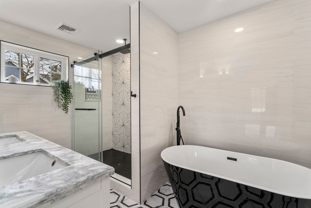 6 Ash Street Natick, MA 01760 - Photo 22 of 39 a bathroom with a granite countertop sink a toilet a shower and a mirror