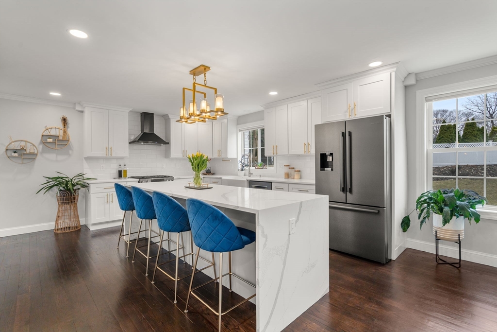 6 Ash Street Natick, MA 01760 - Photo 3 of 39 a kitchen with stainless steel appliances a dining table chairs refrigerator and microwave