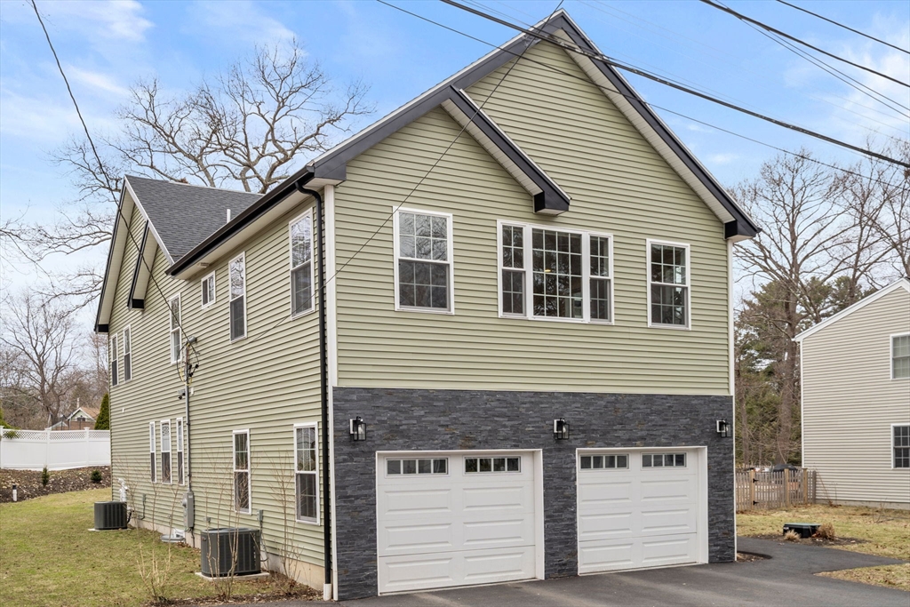 6 Ash Street Natick, MA 01760 - Photo 33 of 39 a front view of a house with garage