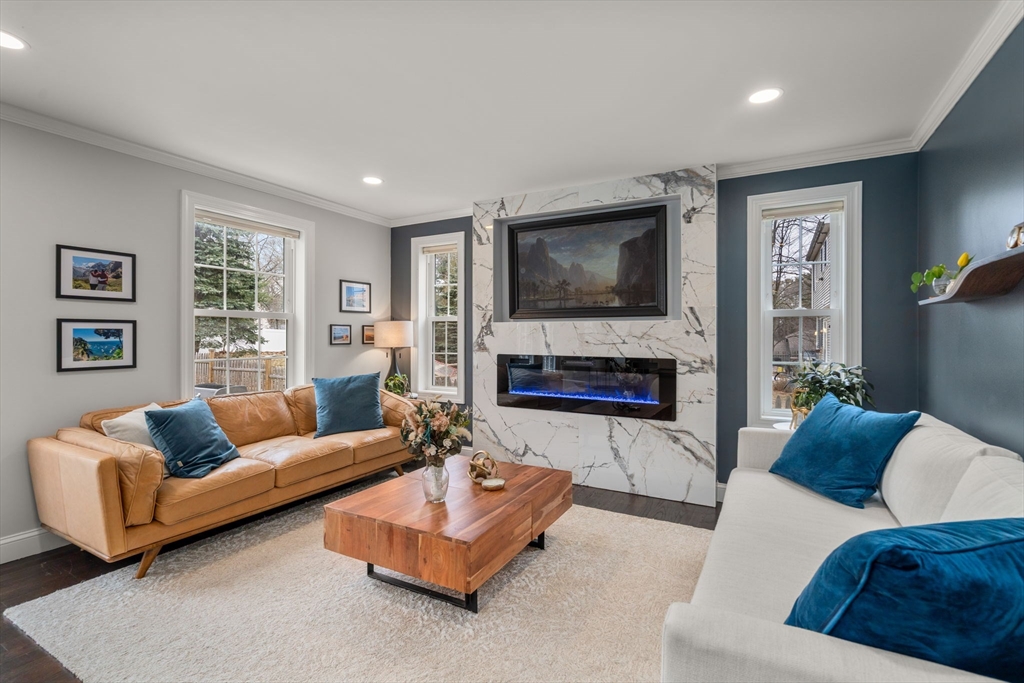 6 Ash Street Natick, MA 01760 - Photo 7 of 39 a living room with furniture flat screen tv and a fireplace
