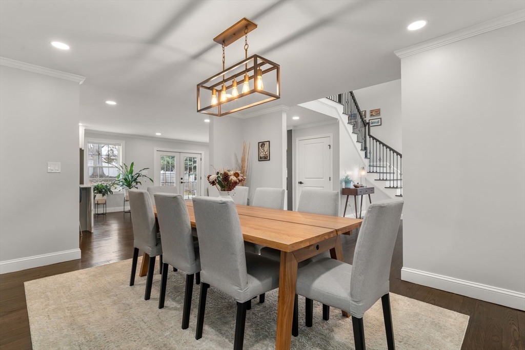 6 Ash Street Natick, MA 01760 - Photo 9 of 39 a view of a dining room and livingroom with furniture wooden floor and a rug