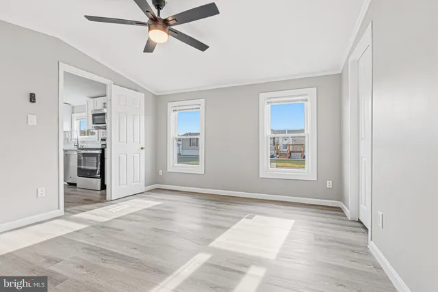 an empty room with closet and windows