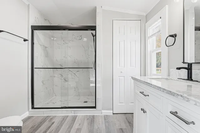 a bathroom with a shower and a sink