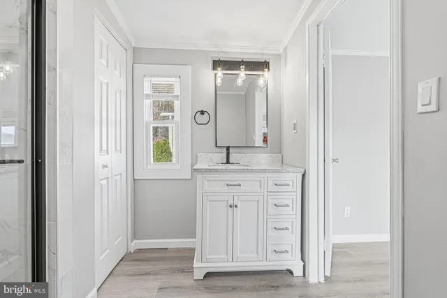 a spacious bathroom with a granite countertop sink a mirror and a