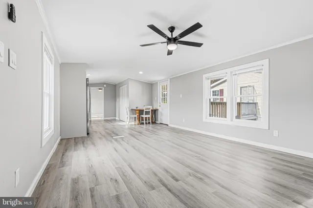 a view of a livingroom with wooden floor and window