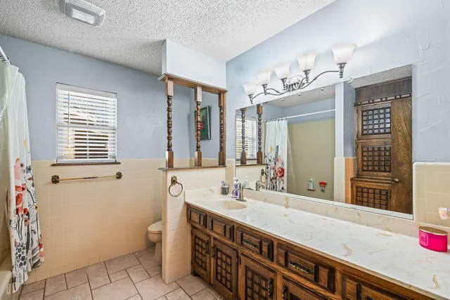 a bathroom with a sink a vanity and a mirror