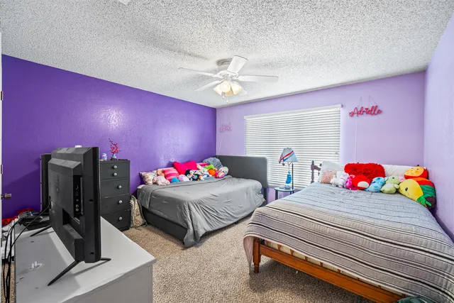 a bedroom with two beds and a chandelier
