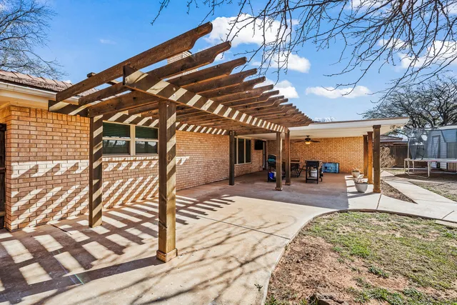 a view of a porch with a table and chairs