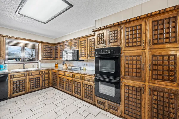 a kitchen with stainless steel appliances granite countertop a stove and a sink