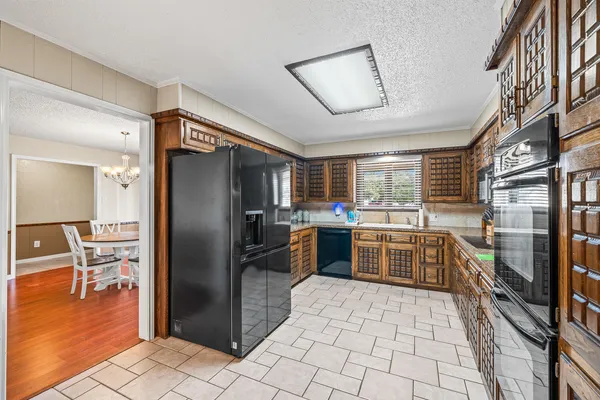 a kitchen with stainless steel appliances granite countertop a refrigerator and a sink